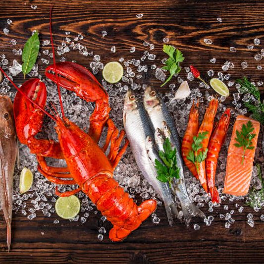 Fresh tasty seafood served on old wooden table.